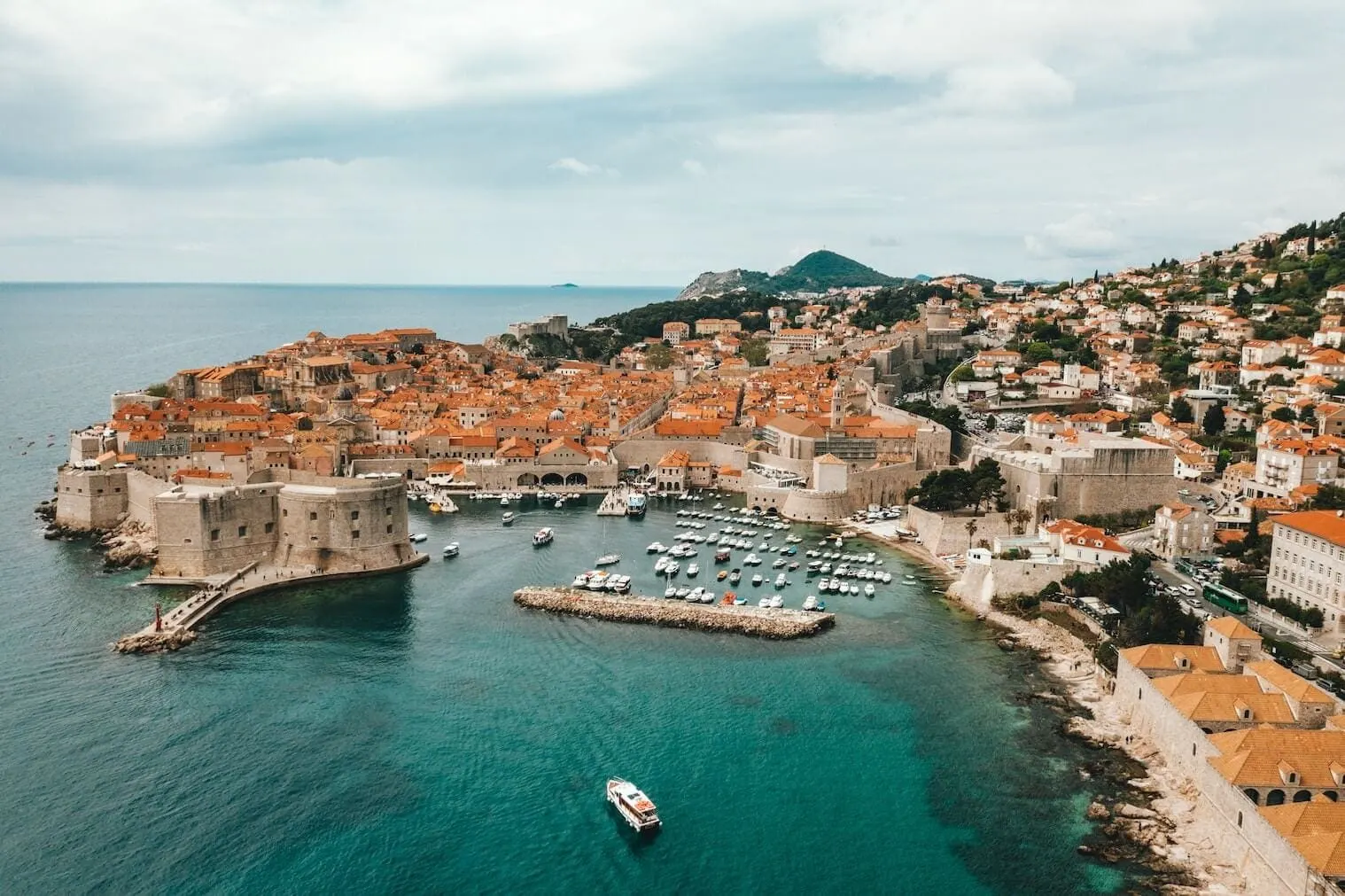 Dubrovnik old town walls and old harbour with moored boats