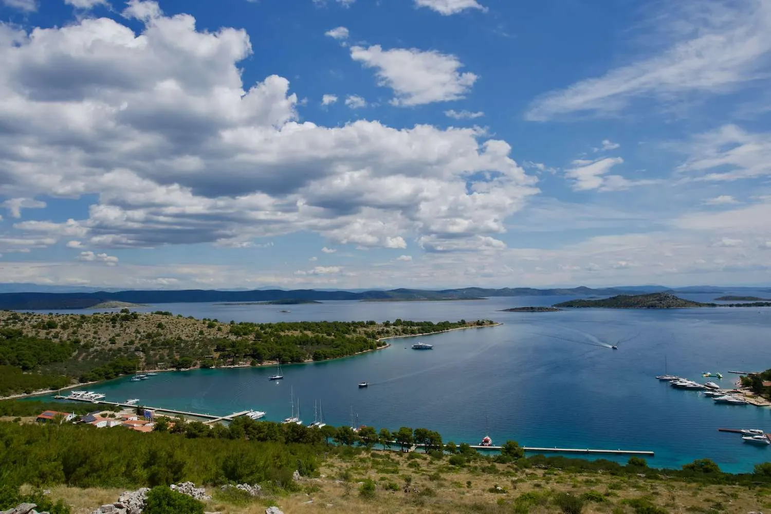 Island bay with a marina pontoon and yachts at anchor, Kornati islands